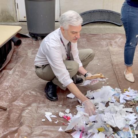 Harborfield's Library Director Ryan Athanas sorts waste during the waste audit